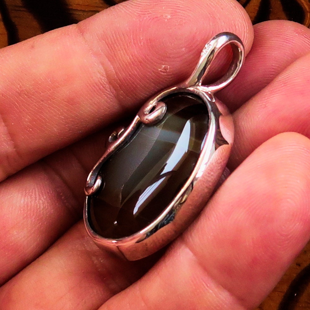 Oval shaped Sterling Silver Artwork Pendant with a black Agate