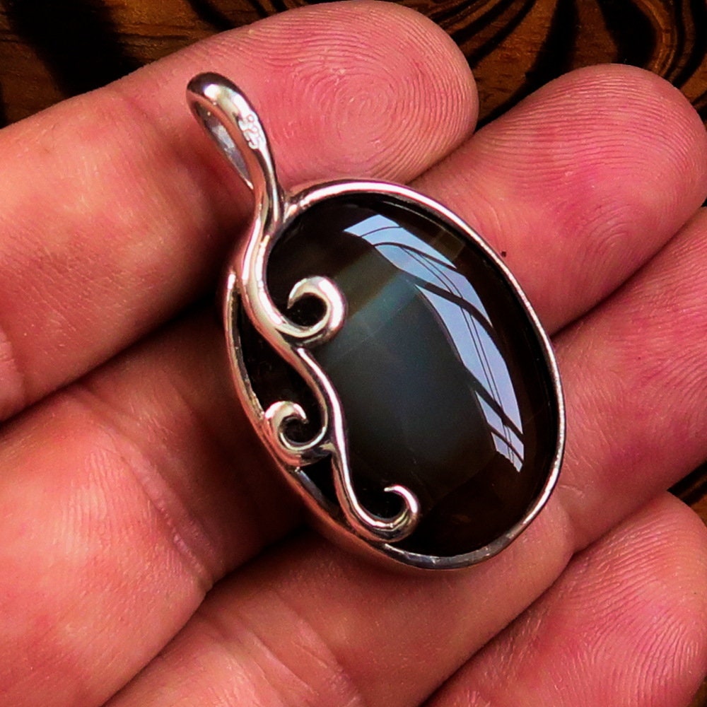Oval shaped Sterling Silver Artwork Pendant with a black Agate
