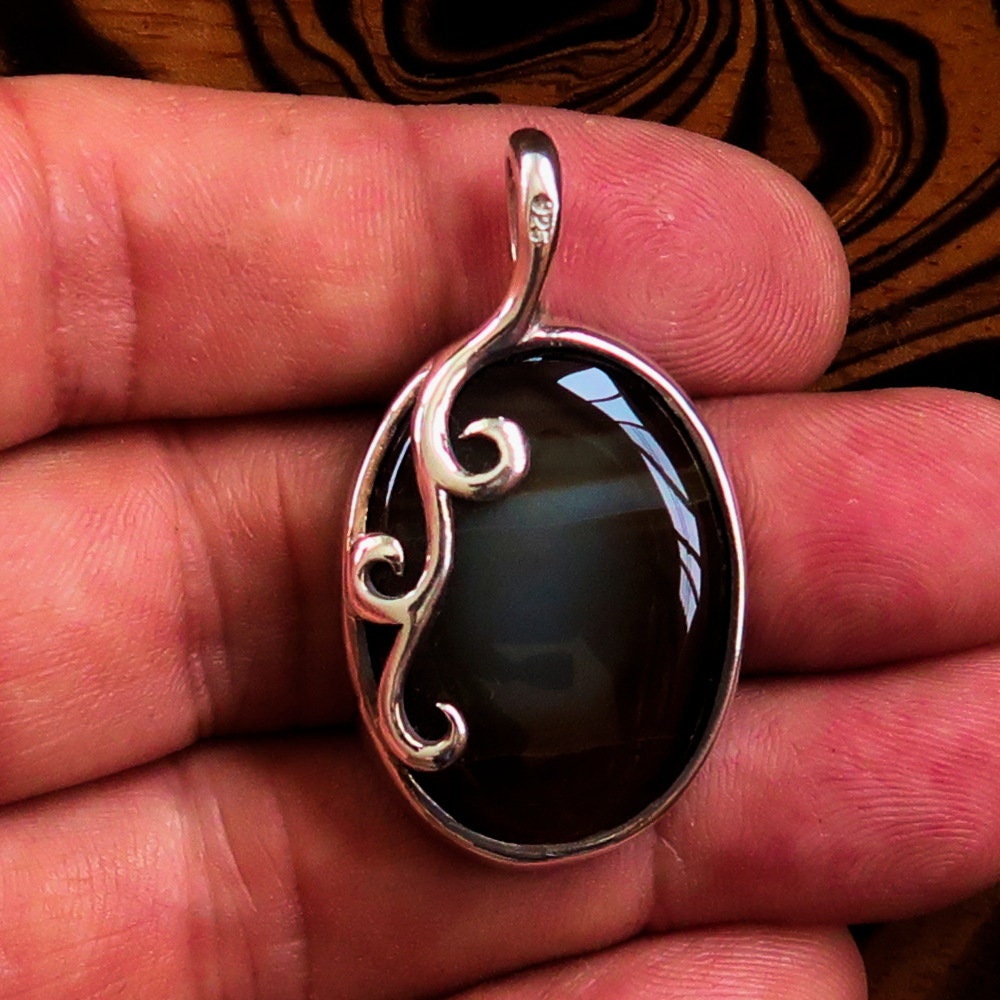 Oval shaped Sterling Silver Artwork Pendant with a black Agate