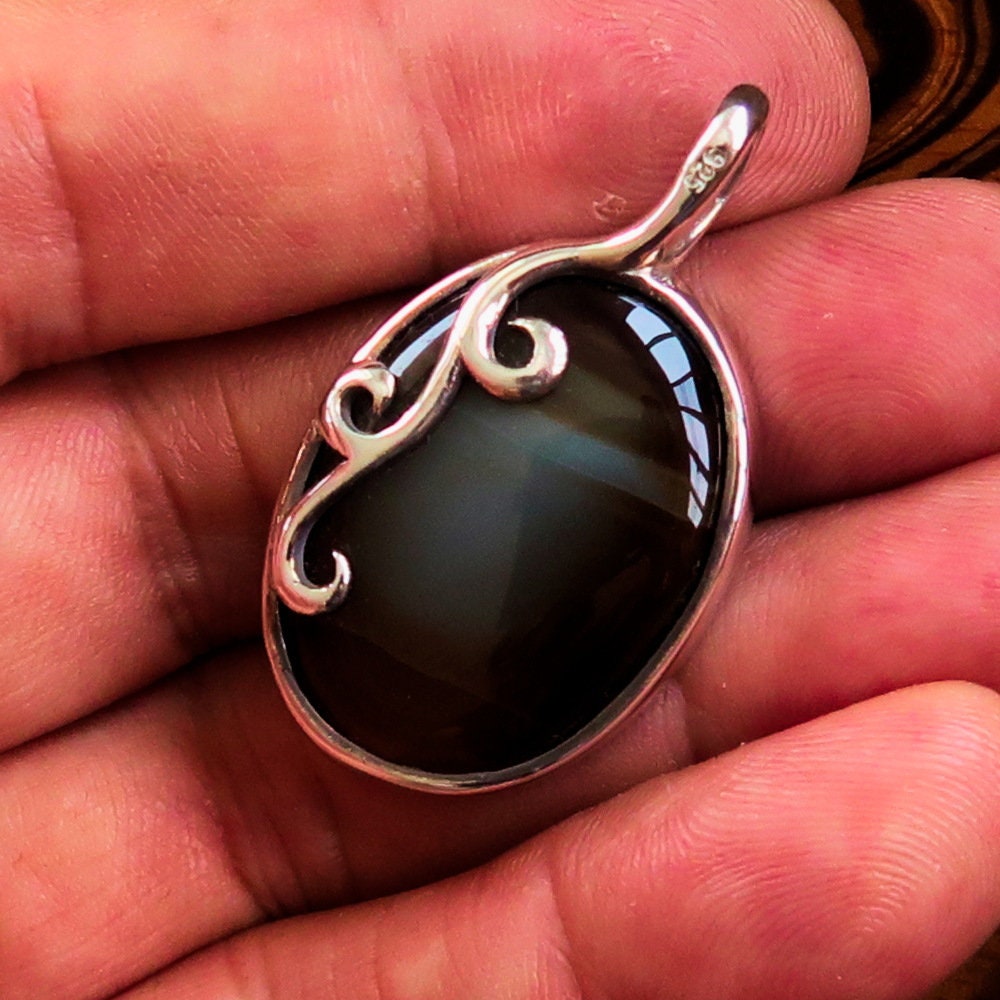 Oval shaped Sterling Silver Artwork Pendant with a black Agate
