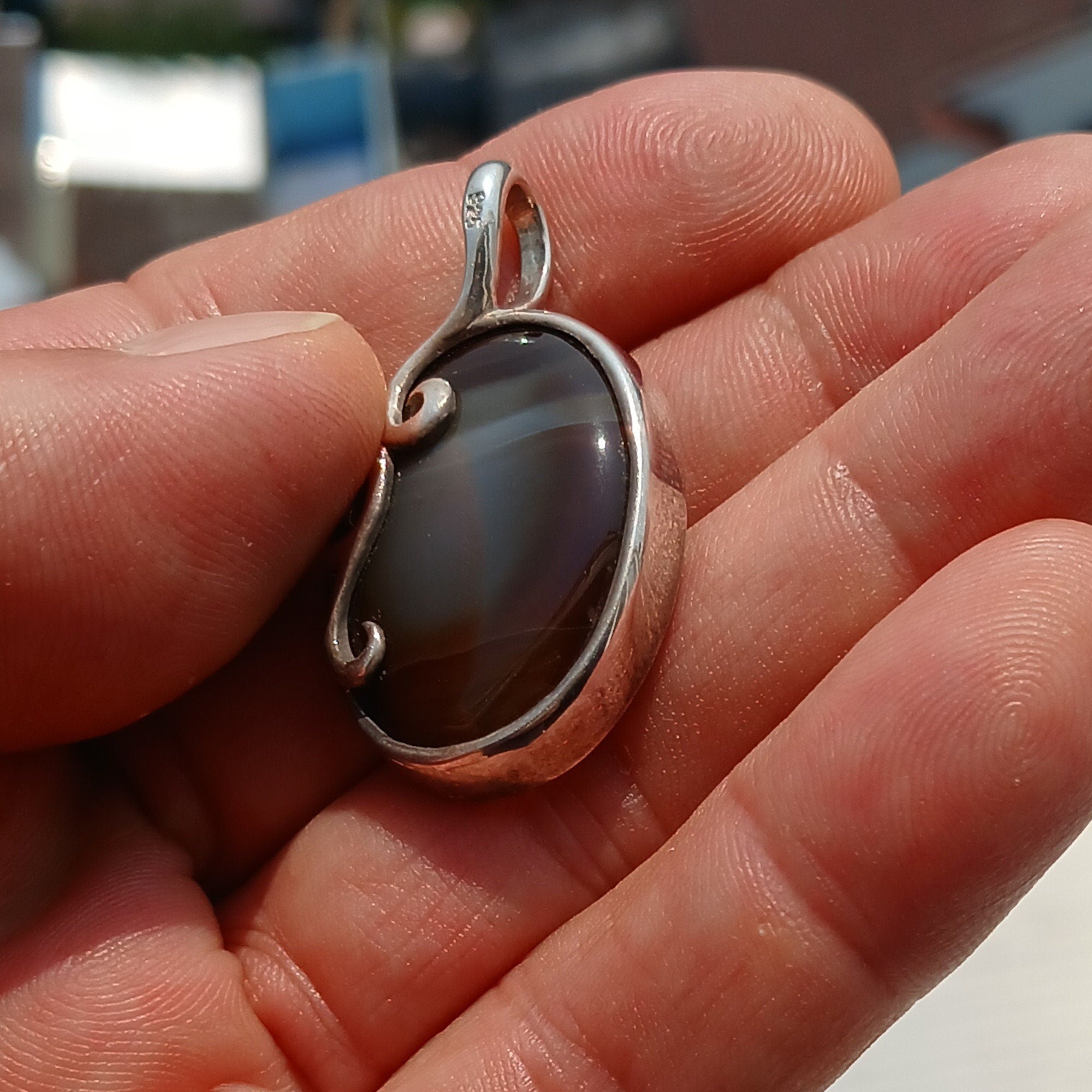 Oval shaped Sterling Silver Artwork Pendant with a black Agate
